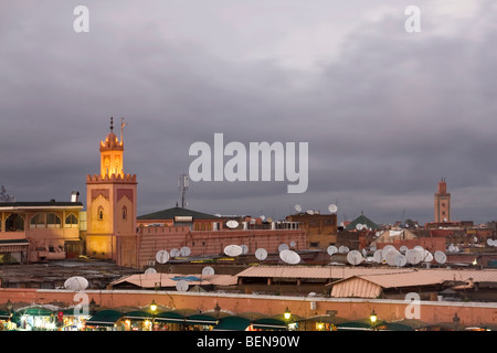 View of Koutobia Mosque minaret from the top at dusk. Satellite dishes in Marrakesh, Morocco Stock Photo