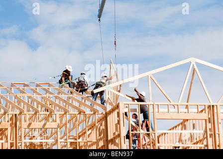 roof trusses being put in place at a construction site Stock Photo