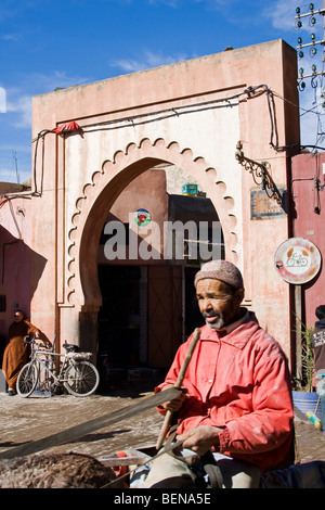 Moroccan man on a wagon cart with a donkey in Marrakech medina. Morocco, North Africa Stock Photo