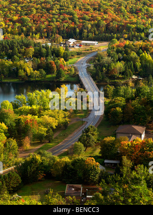 Aerial fall nature scenery of a winding road crossing the Lake of Bays. Dorset, Muskoka, Ontario, Canada. Stock Photo