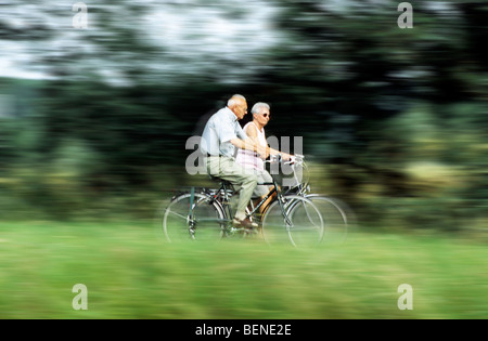 Elderly couple riding their bikes, Belgium Stock Photo