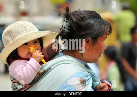 CAJABAMBA PERU - SEPTEMBER 6: Woman carrying child on back in Cajabamba, Peru on September 6, 2009 Stock Photo