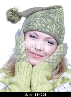 portrait of beautiful dreamy blonde girl in green sweater, mittens and winter cap with bob Stock Photo