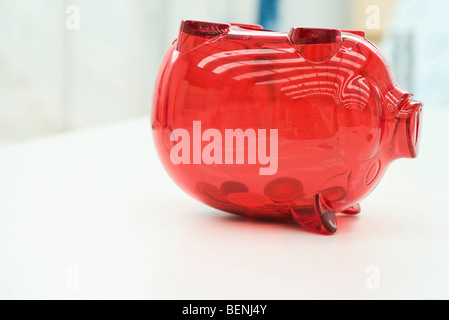 Coins in upside down piggy bank Stock Photo