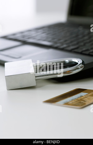 Padlock on laptop computer, credit card nearby Stock Photo