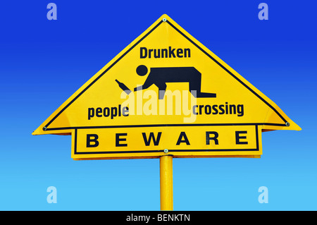 warning sign 'Drunken people crossing' on blue with clipping path Stock Photo