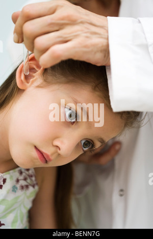 Doctor putting drops in little girl's ear, cropped Stock Photo