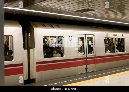 Tokyo Metro filled with passengers on rush hour Stock Photo