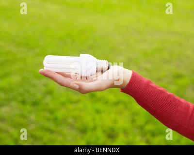 Woman holding light bulbs. Selective focus, copy space Stock Photo