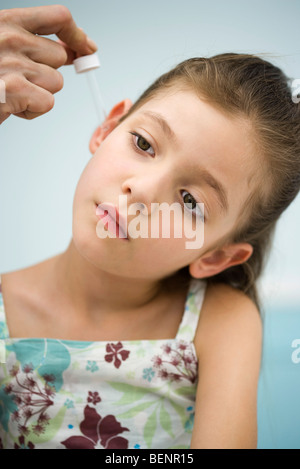 Doctor putting drops in little girl's ear, cropped Stock Photo