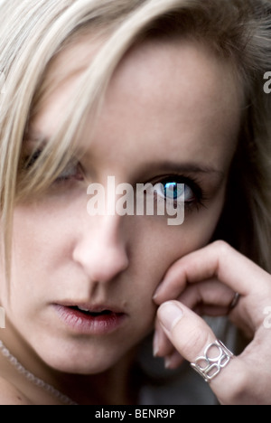 The intense stare of a young blond woman with blue green eyes.  Photo by Gordon Scammell