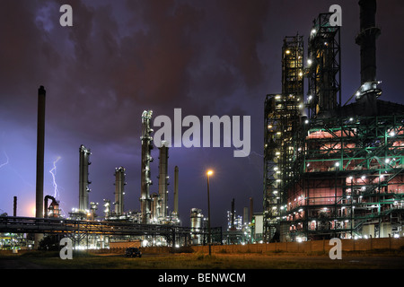 Lightning during thunderstorm above petrochemical industry in the Antwerp harbour at night, Belgium Stock Photo