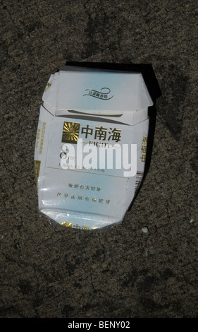 An empty pack of Eight cigarettes is tossed away on the street Stock Photo