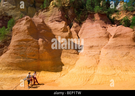 Tourists visiting the old ochre quarry at Roussillon, Vaucluse, Provence-Alpes-Côte d'Azur, Provence, France Stock Photo