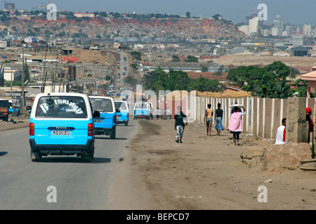 People walking along busy road in suburb of capital city Luanda, Angola, Southern Africa Stock Photo