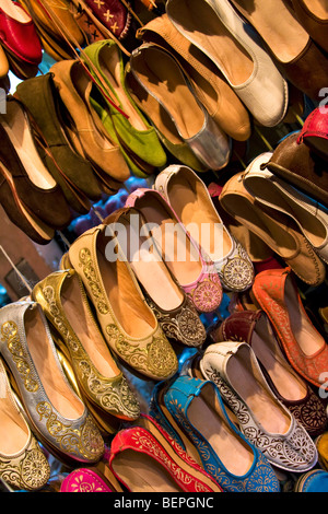 Colourful traditional Moroccan leather slippers shoes and babouches on display in a shop in the souk. Medina Marrakesh, Morocco Stock Photo