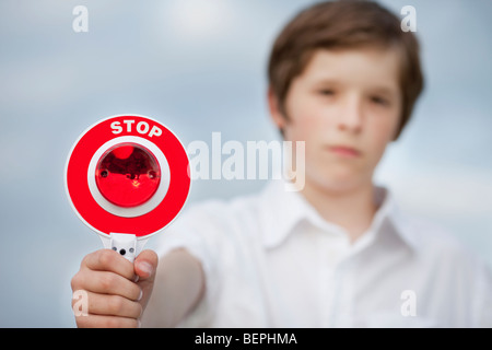 young boy holding up stop sign Stock Photo