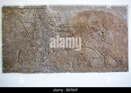 Relief showing the Assyrian king Ashurnasirpal II (9th century BC) hunting a lion, Pergamon Museum, Berlin, Germany Stock Photo