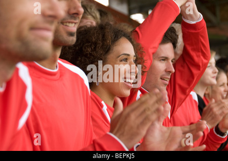Fans clapping at football match Stock Photo