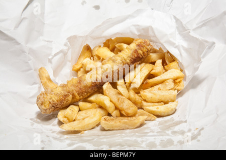 Take away sausage or saveloy and chips wrapped in white paper. Stock Photo