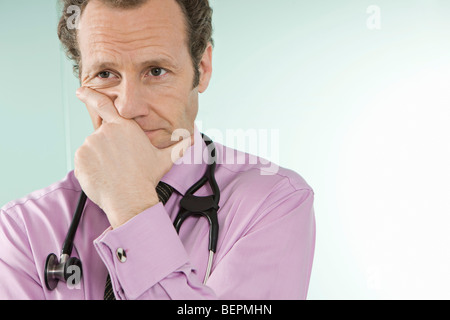 A doctor holding his hand over his mouth Stock Photo