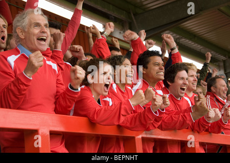 Fans celebrating at football match Stock Photo