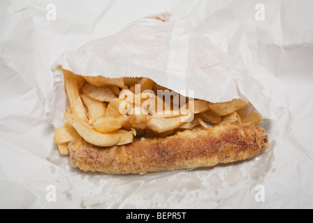 Take away sausage or saveloy and chips wrapped in white paper. Stock Photo