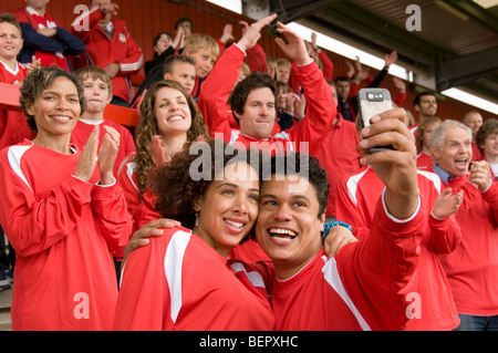 Football fans photographing themselves Stock Photo
