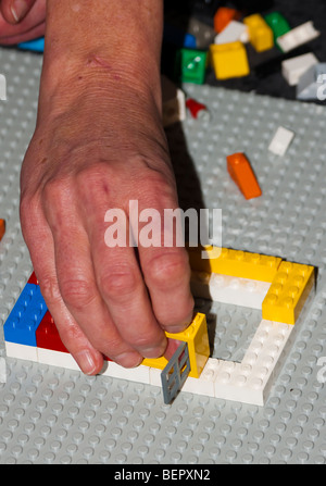 Teamwork building LEGO Stock Photo