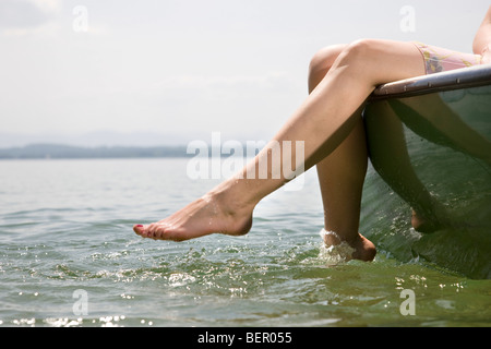 Topless woman sunbathing on a boat Stock Photo - Alamy