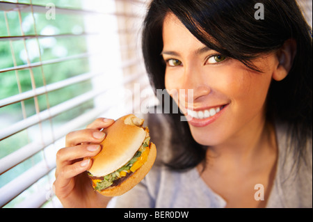 Woman eating a burger Stock Photo