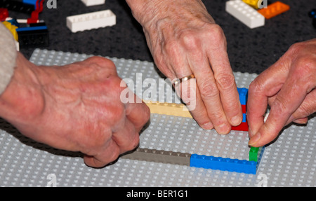 Teamwork building LEGO Stock Photo