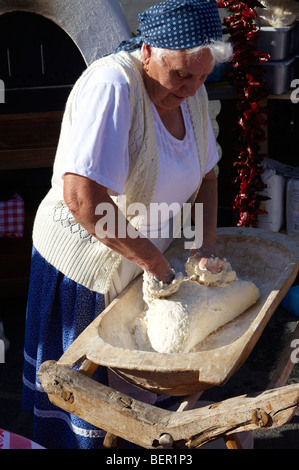 Woman [ south Alfoldi region ] [ Del Alfodi Regio South Alfoldi ]  making dough for lepeny bread. Hungary Stock Photo
