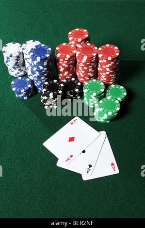 Four aces and poker chips on table Stock Photo
