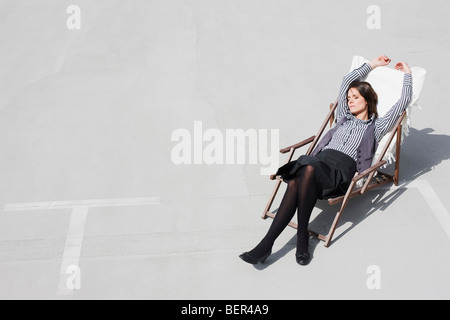 woman relaxing in deck chair Stock Photo