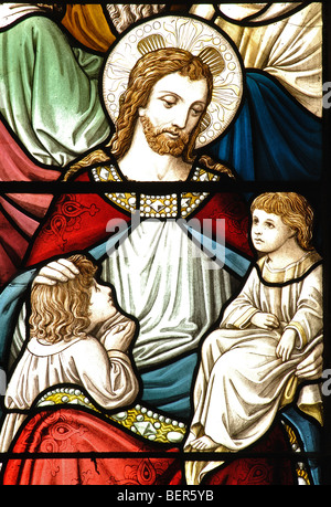 Suffer the little children stained glass in St. Michael and All Angels Church, Appleby Magna, Leicestershire, England, UK Stock Photo