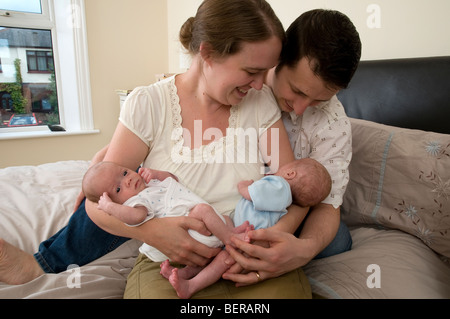 Parents holding identical twin baby boys, premature babies Stock Photo