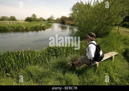 Walker on West Beck chalk stream river, Wansford, Driffield, East Yorkshire, UK Stock Photo