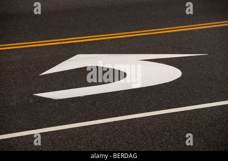 White arrow on pavement. Stock Photo