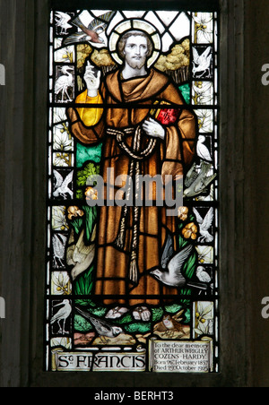 A stained glass window by J Powell & Sons depicting Saint Francis of Assisi, St Margaret's Church, Cley-next-the-Sea, Norfolk Stock Photo