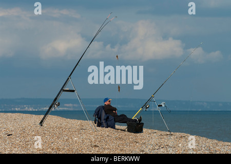 Sea angler waits to catch fish at Dungeness, Kent, England Stock Photo ...