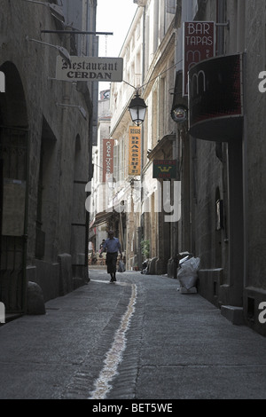 Man walking down backstreet in Monteplier , France Stock Photo