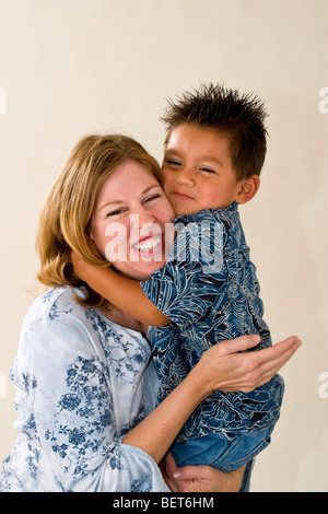 Series of images of a single mom holding her newly adopted 3 year old Hispanic foster son. Interracial California  United States  MR Stock Photo