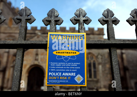 Generic image of an cast iron fence outside a church with a Smartwater sign warning off potential criminals. Stock Photo