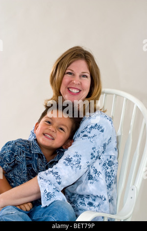 Series of images of a single mom holding her newly adopted 3 year old Hispanic  foster son. California MR United States Stock Photo