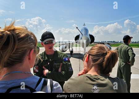 Pilot talking to tourists in front of fighter jet aircraft at airshow in Koksijde, Belgium Stock Photo