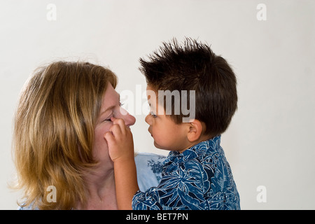 Series images of single mom holding her newly adopted 3 year old Hispanic foster son.Still exploring getting to recognize life change California USA Stock Photo