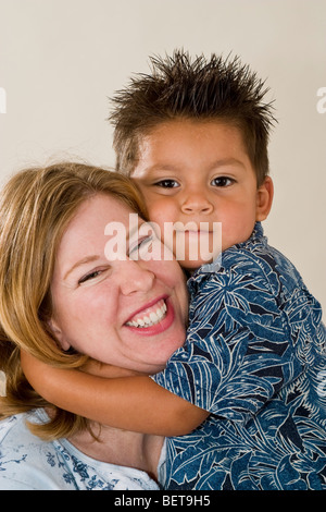 Series of images of a single mom holding her newly adopted 3 year old Hispanic  foster son. California United States  MR Stock Photo