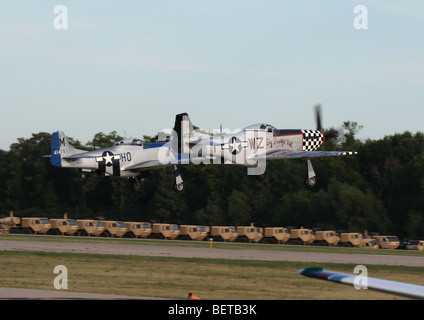 A Pair of P-51 Mustangs take off in formation from EAA Airventure 2009 Stock Photo