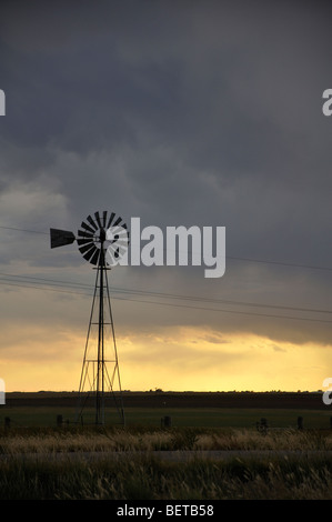 Windmill and approaching storm in Texas Stock Photo